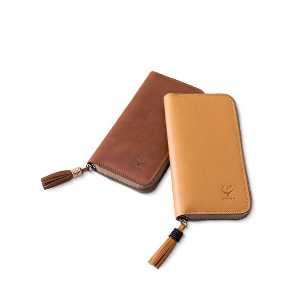 Two leather pouches with beaded tassels on a white background