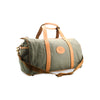 Green duffel bag with brown leather straps on a white background