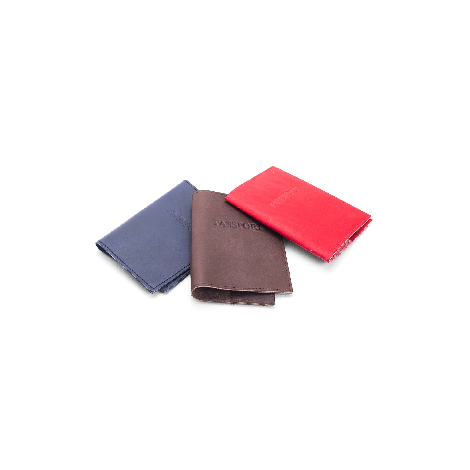 Three passport holders in blue, brown, and red 
