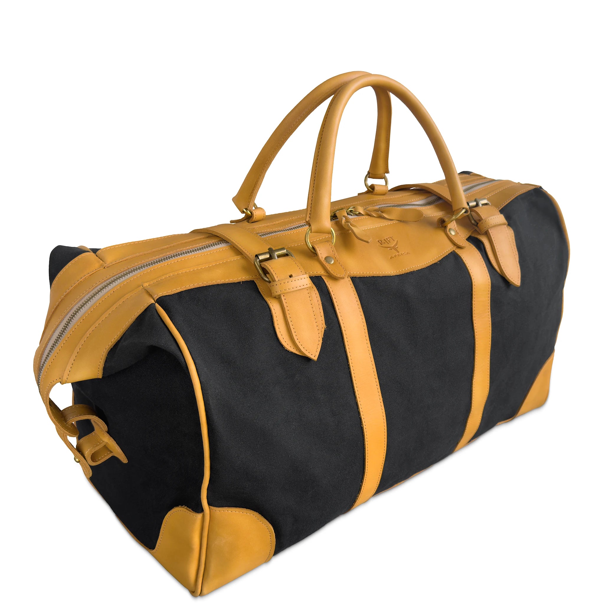 A black and tan leather-and-canvas duffel bag with dual top handles, buckle details, and a zip-around closure, photographed on a clean white background.