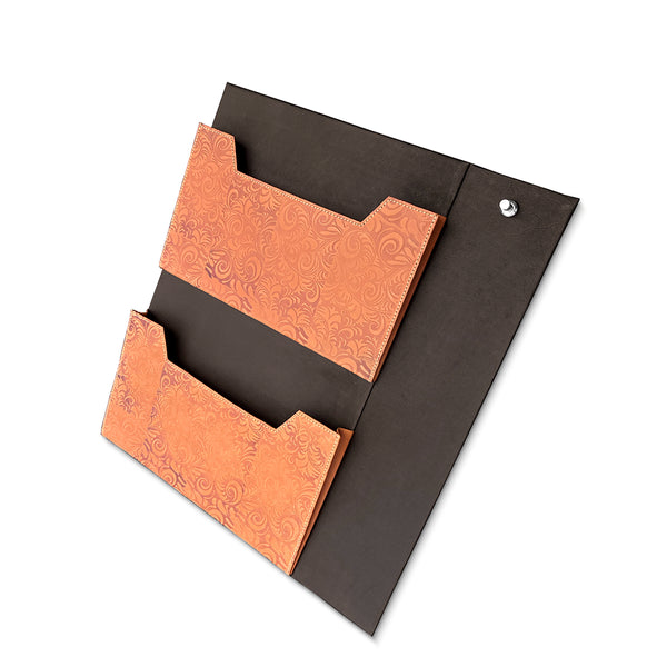 Brown leather laundry organiser  with embossed design on a white background