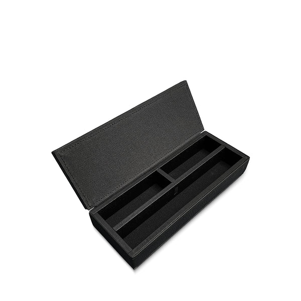 Black textured box with compartments on a white background