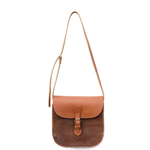 Brown leather crossbody bag with a strap on a white background