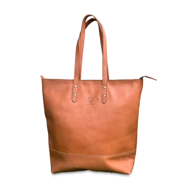 Brown leather tote bag with visible brand logo on a white background