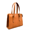 A tan leather tote bag with double shoulder straps, gold-tone buckle details, and a small embossed logo on the front, shown against a plain white background.