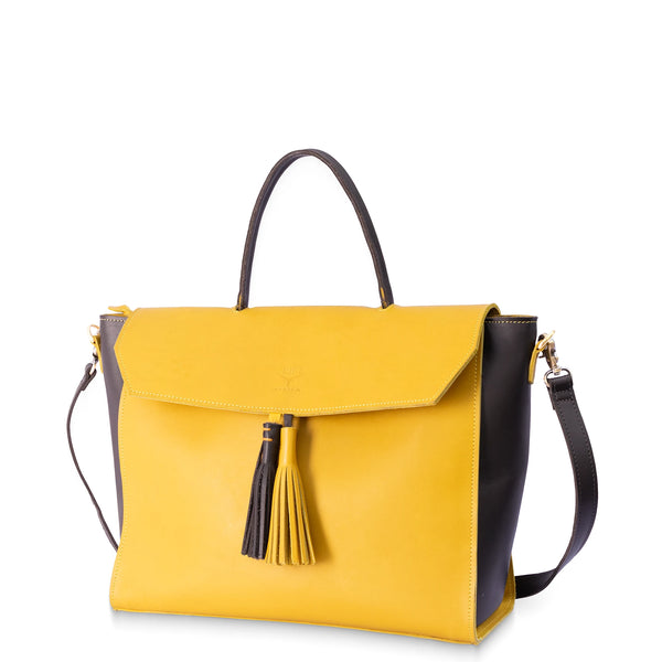 Yellow handbag with black accents and a tassel on a white background