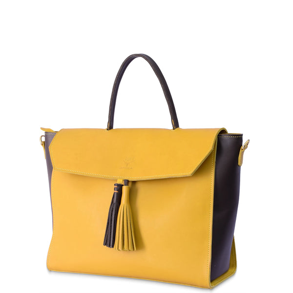 Yellow handbag with black accents and a tassel on a white background