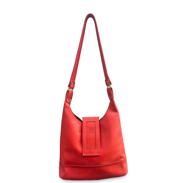Red handbag with a strap on a white background