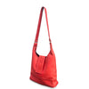 Red handbag with a strap on a white background