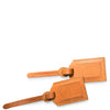 Two brown leather luggage tags on a white background