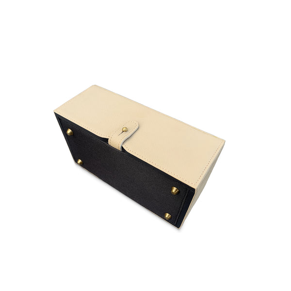 Two-tone black and beige tissue box cover with gold buttons on a white background