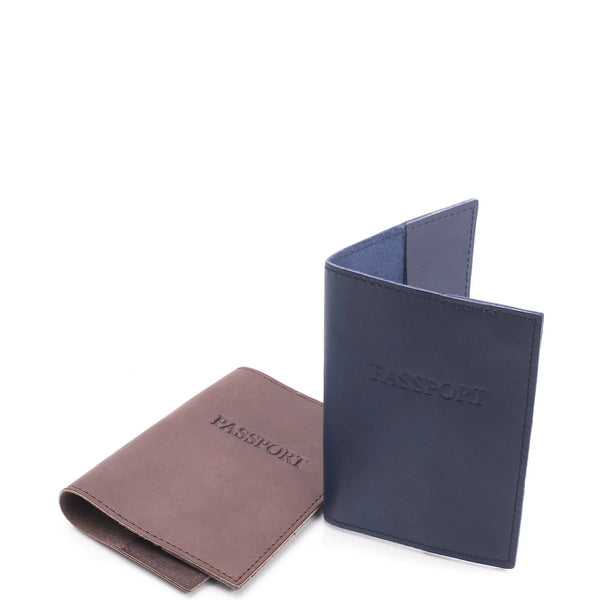 Two leather passport holders, one brown and one navy, on a white background.