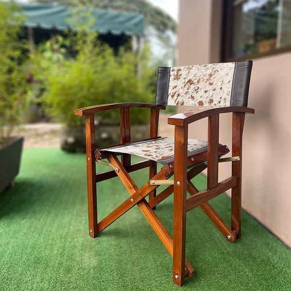 Wooden chair with patterned seat and backrest on a green surface