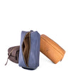 Three leather toiletry bags in blue, brown, and tan on a white background