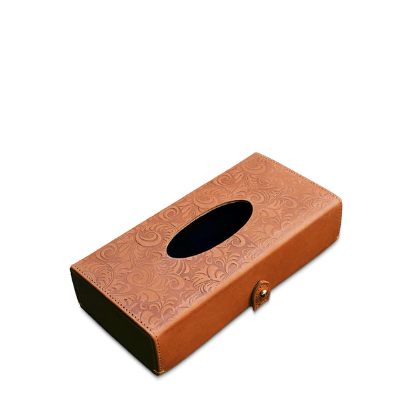 Brown leather tissue box with embossed design on a white background