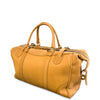 A tan leather duffel bag with double top handles, a top zipper, and a detachable shoulder strap, photographed on a clean white background.