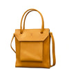 A tan leather tote bag with a front flap pocket, dual top handles, and a detachable shoulder strap, shown on a plain white background.