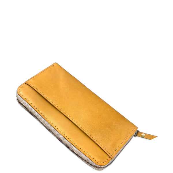A tan leather zip-around wallet with a fold-over flap and silver-toned zipper, shown on a plain white background.