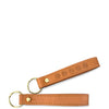 Brown leather keychain with embossed design on a white background