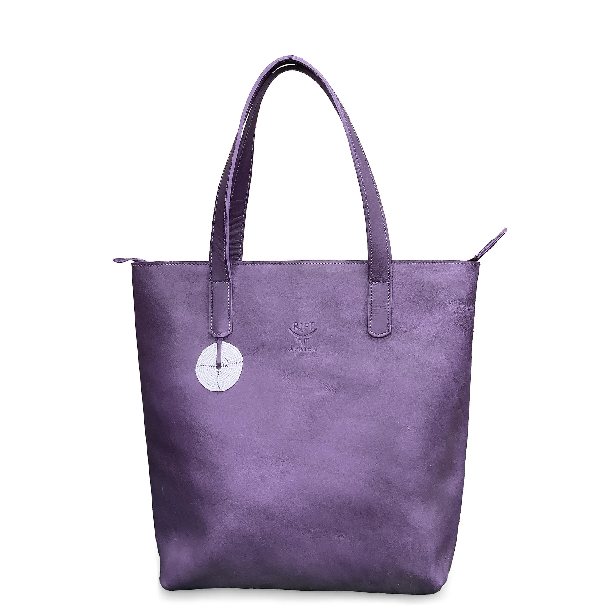 Purple leather tote bag with a visible brand logo on a white background