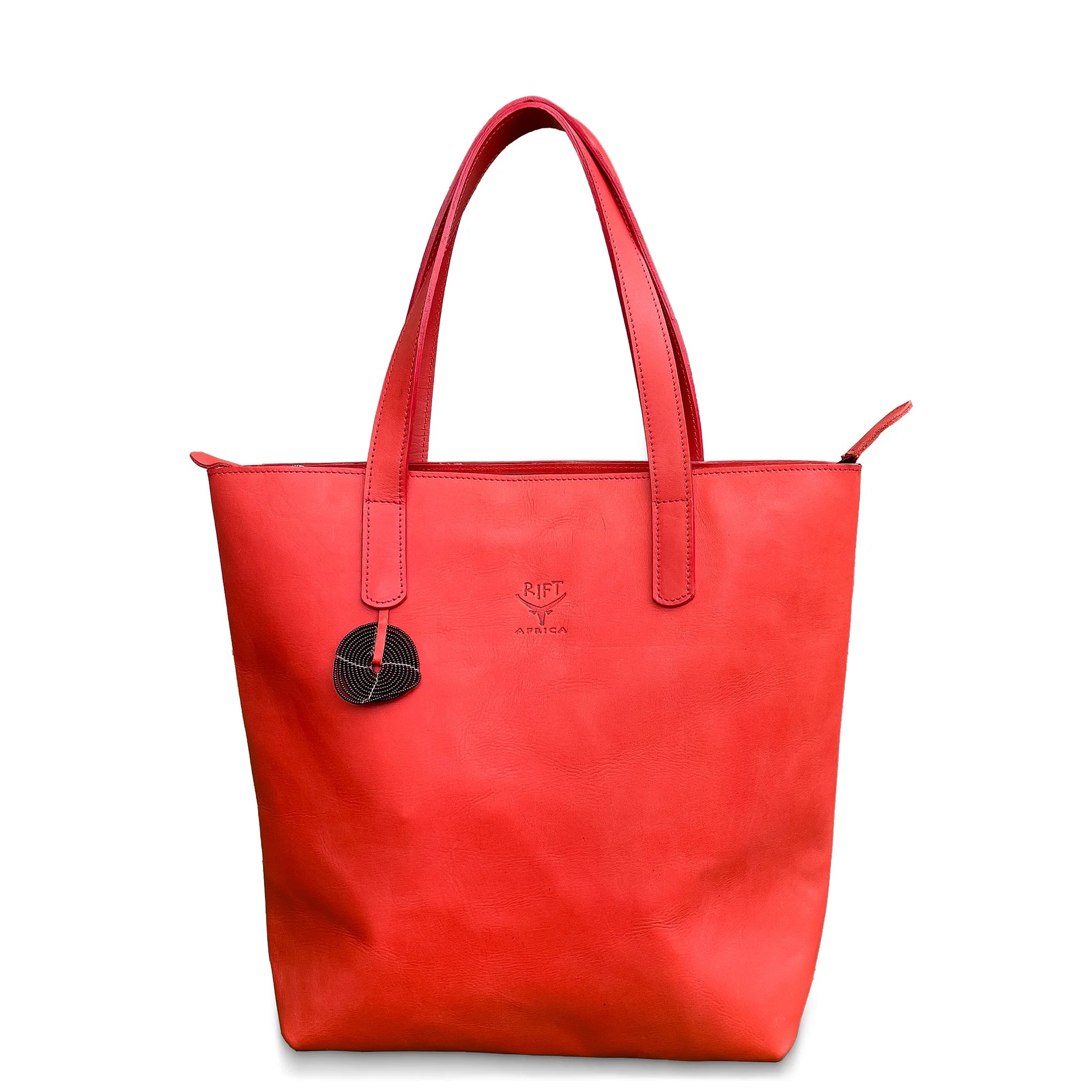 Red leather tote bag with a brand logo on a white background