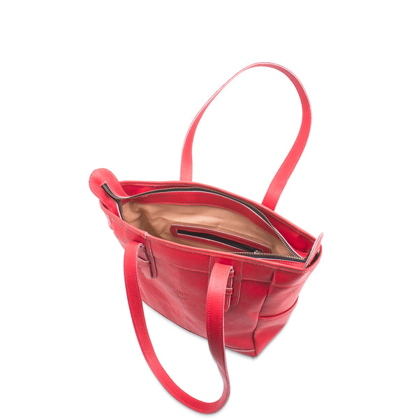 Red leather handbag with open top on a white background